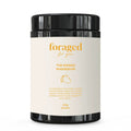 A black plastic supplement jar with a cream-colored label reading 'foraged for you' and 'THE MANGO MAGNESIUM' in gold text, on a plain white background.